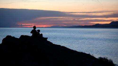Two people watch the sunset over the Great Salt Lake from Ladyfinger Point on Antelope Island on Monday, June 5, 2023.Kristin Murphy, Deseret News